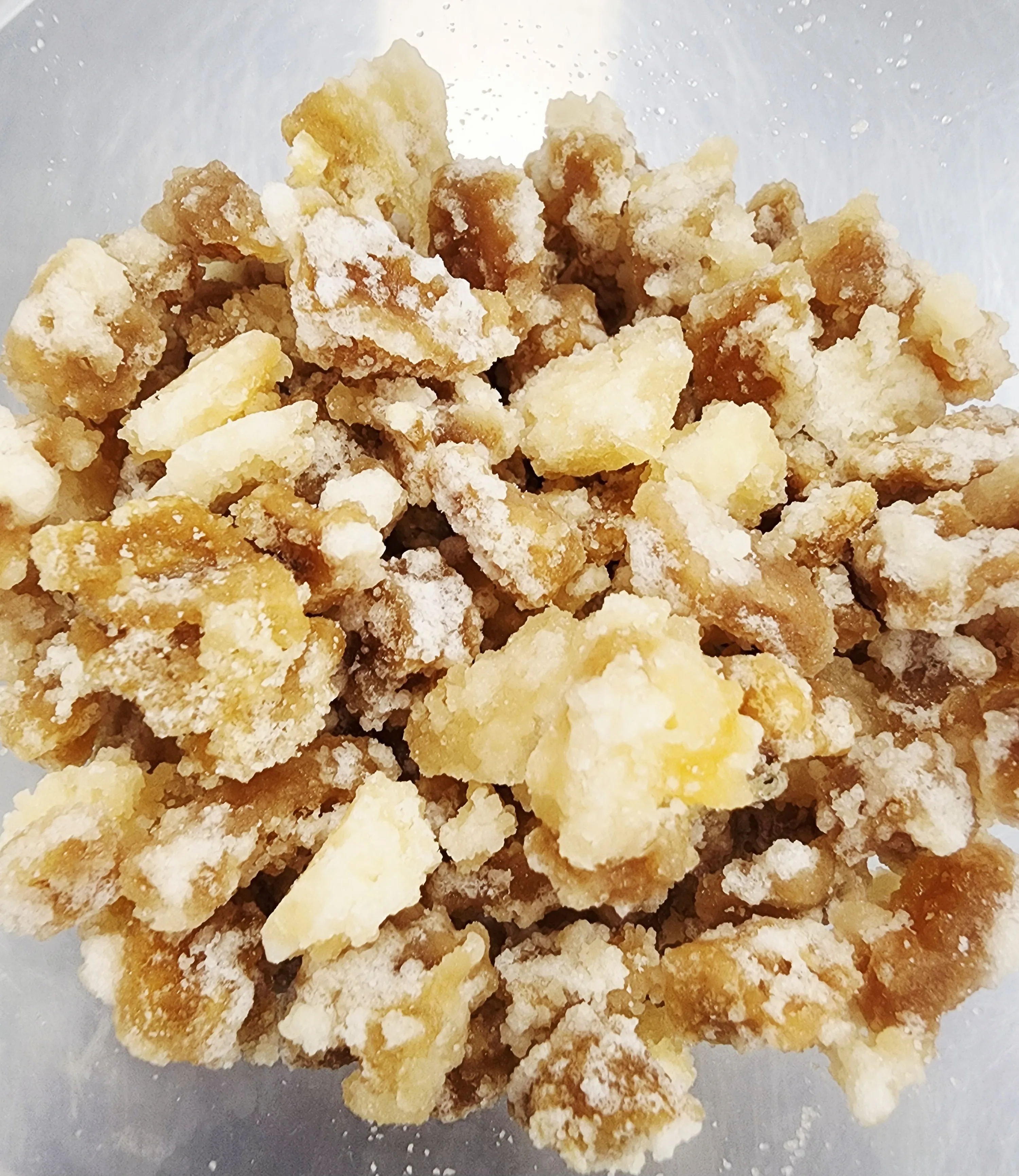 A bowl of hand-candied ginger pieces, sugar-crusted, made in-house