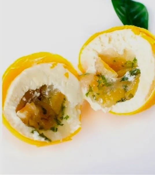 Lemon trompe-l'œil cut open, revealing meringue cream and candied-lemon curd